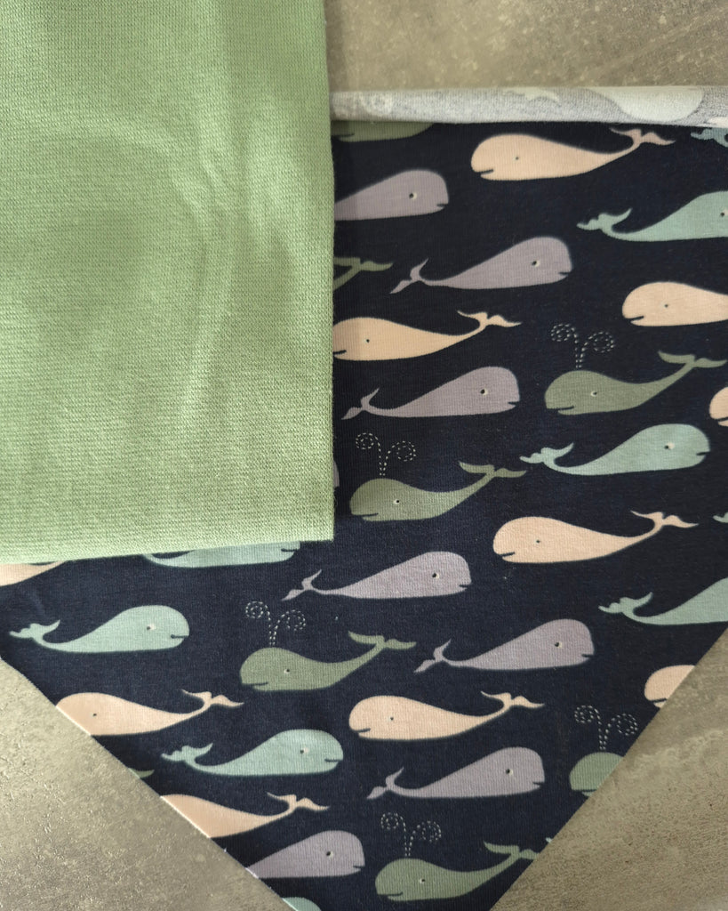 Fabric swatches with green fabric and navy fabric with whale pattern