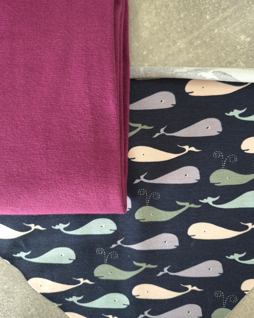 Fabric with whale pattern on a dark blue background