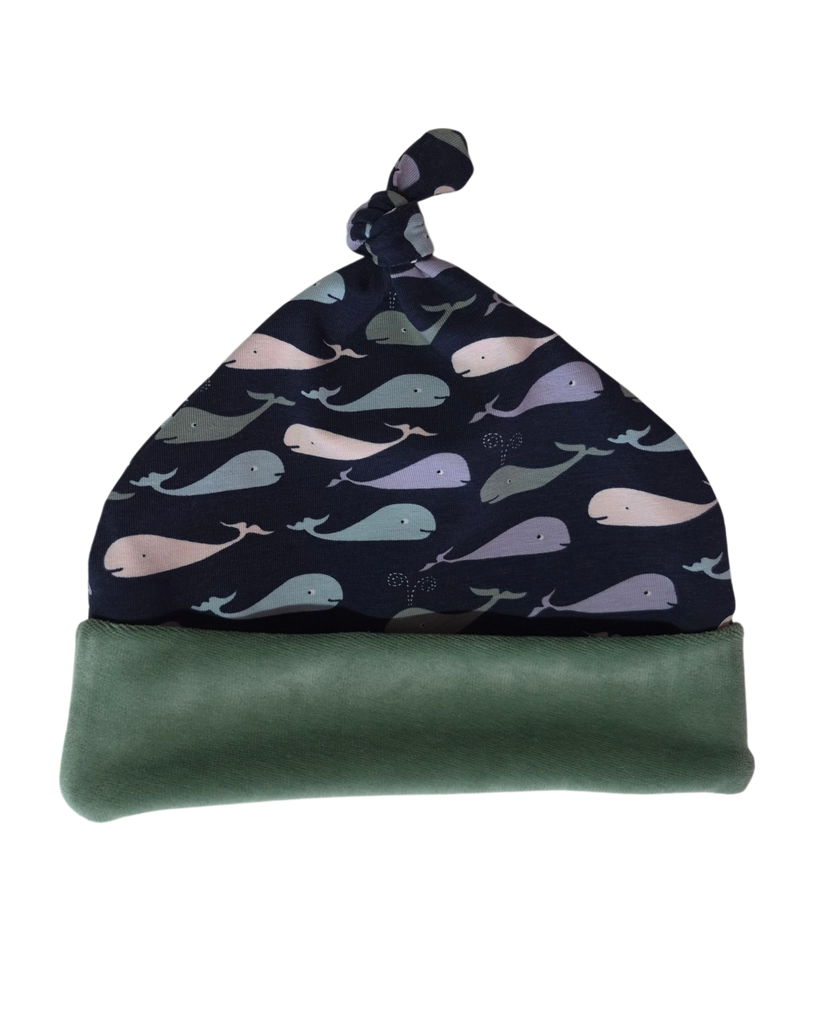 Whale print Top Knot Baby hat with whale pattern on a white background