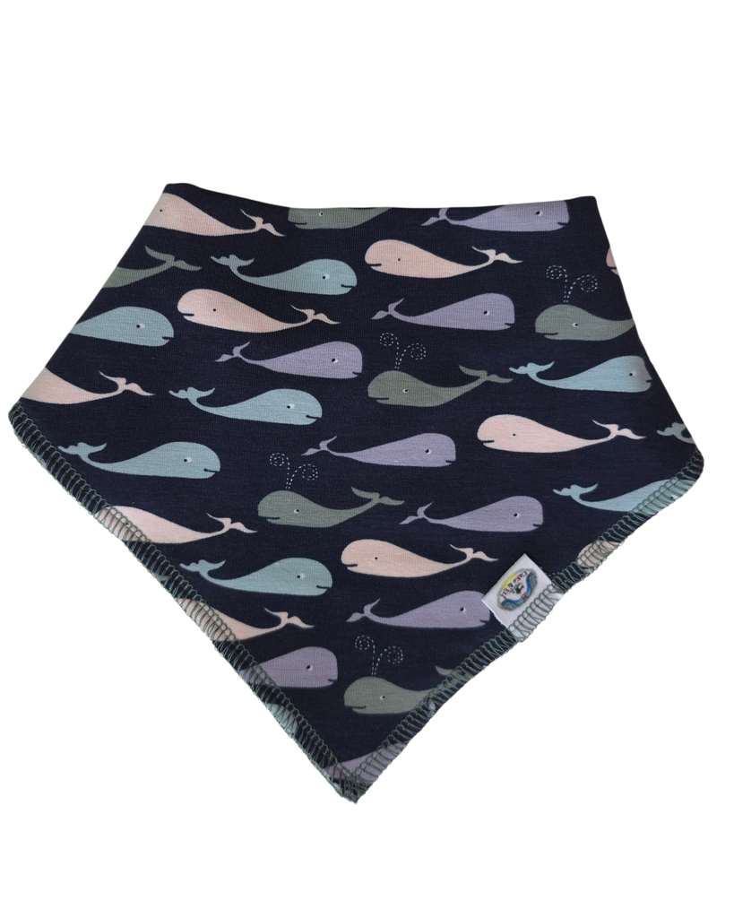 Navy blue bandana bib with colorful whale pattern on a white background