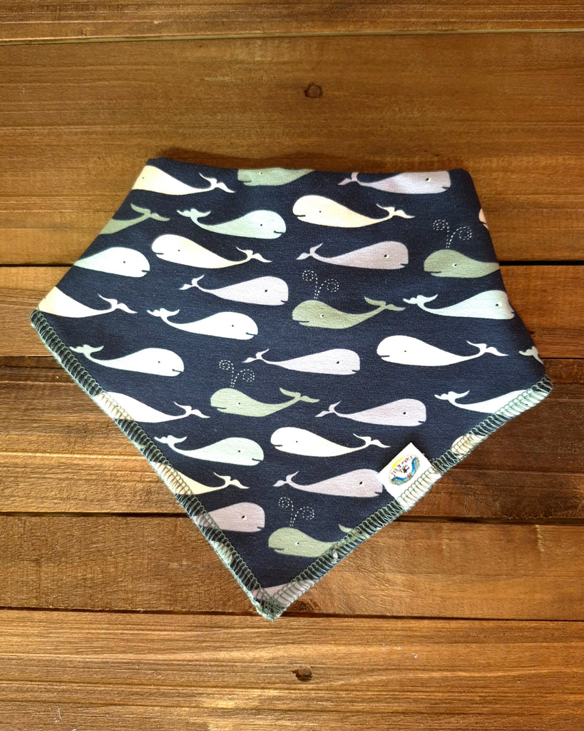 baby Bib Fabric with whale pattern on a wooden surface