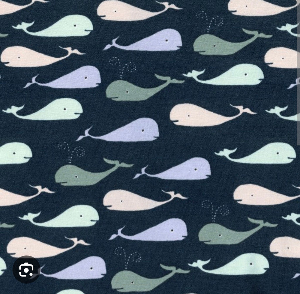 Pattern of colorful whales on a dark blue background