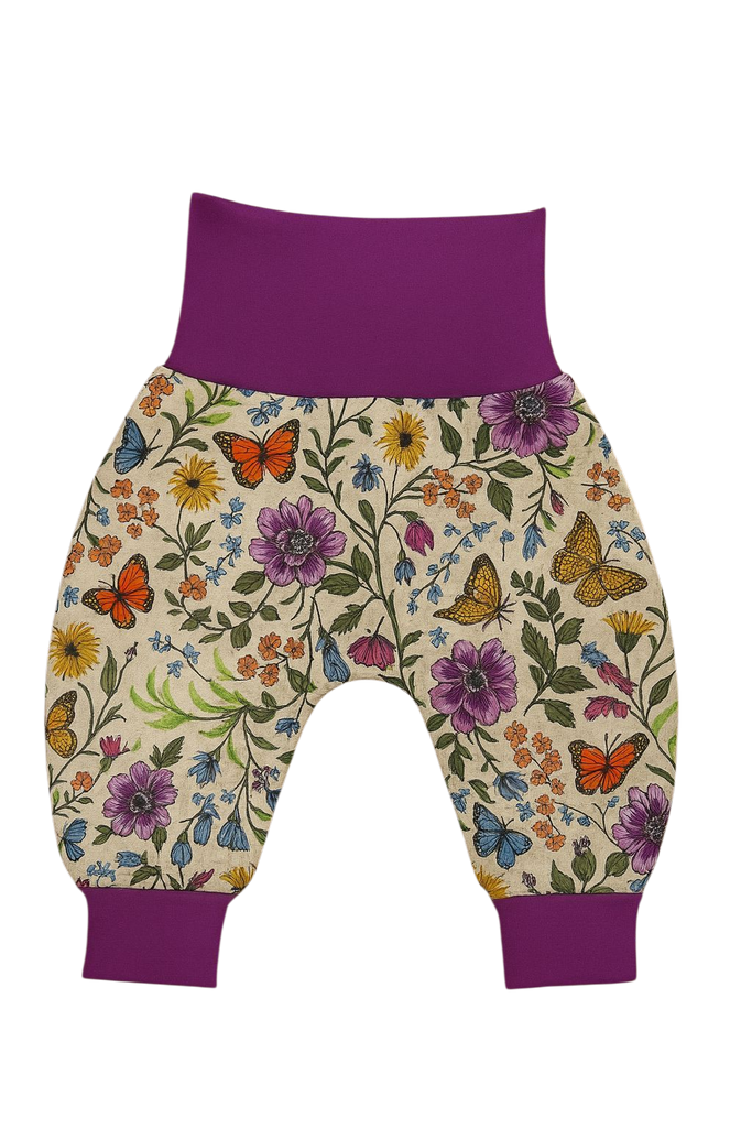 Floral-patterned baby harem pants with purple accents on a white background
