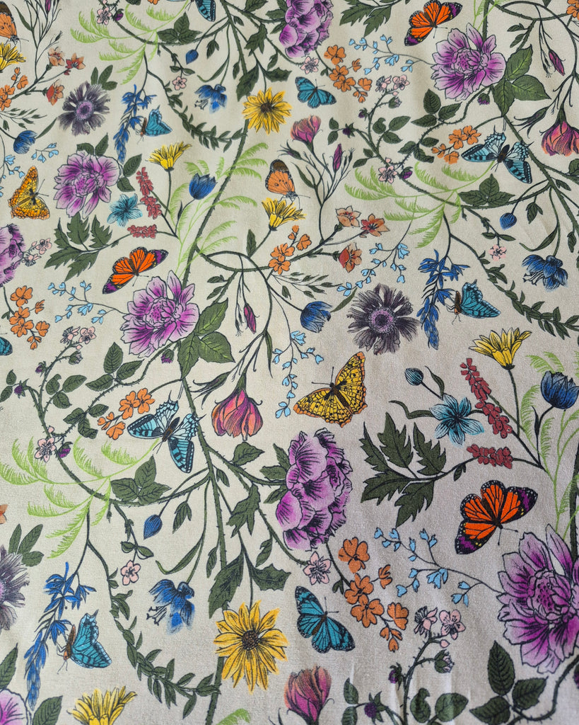 Organic cotton jersey fabric GOTS-certified organic with a hand drawn Wildflowers and Butterflies print